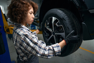 Fototapeta na wymiar Car is on scheduled maintenance in modern auto repair shop