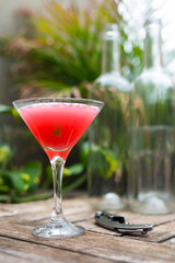 red cocktail with ice in a glass