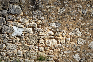 old stone wall textured with rough stone and sand cement filler
