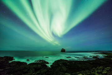 Aurora borealis over Reykjanes sea stack, Iceland