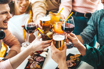 Multiracial friends celebrating party drinking cocktails at bar restaurant - Young people having fun hanging out on weekend day - Life style concept with guys and girls enjoying time together