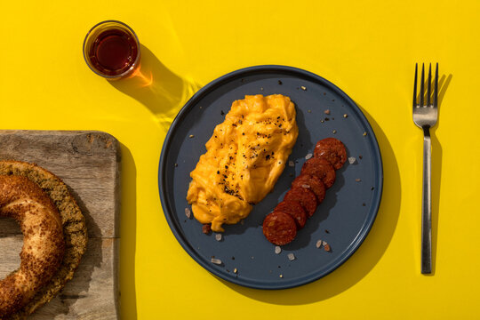 Turkish breakfast. Scramble eggs and fried sausage. "Semit" with olive pate. Tea in glass. 
