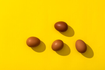 Four eggs on the yellow background.