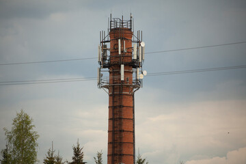 Brick tower. Old pipe. Antennas on brick tower.