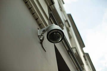 Surveillance camera. Spherical video camera on house. Street recorder.