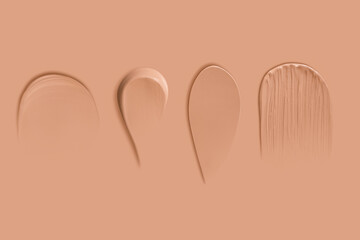Set of texture strokes of dark foundation on a beige background.