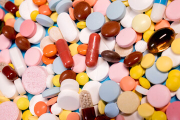 Background with the many colorful different capsules and pills. The concept of medical treatment