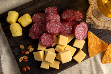 picada snack chizitos mani fries salami cheese and nachos on wooden board