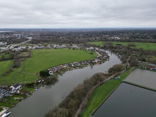 Fototapeta na wymiar Riverside houses on River Thames Shepperton Surrey UK drone aerial view