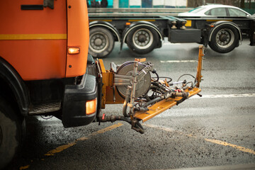 Washing equipment on road. Orange equipment on track.