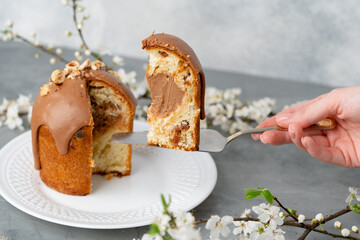 Hand holding piece of Easter cake on dessert spatula