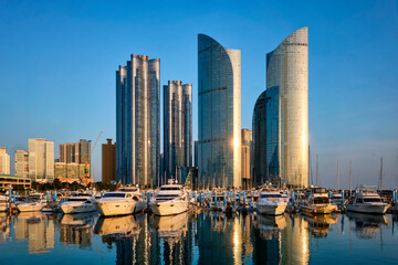 Busan marina with yachts, Marina city skyscrapers with reflection on sunset, South Korea