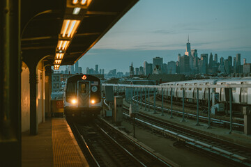 View of the Manhattan skyline and approaching subway train, at Smith-9th Streets station, Brooklyn, New York