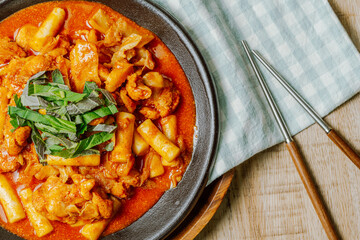 Dakgalbi, korean style Spicy Stir-fried Chicken with rice cake, Chicken pieces marinated in a gochujang, and stir-fried in a flat grill pan with cabbage, sweet potato, carrots, and tteok (rice cakes).