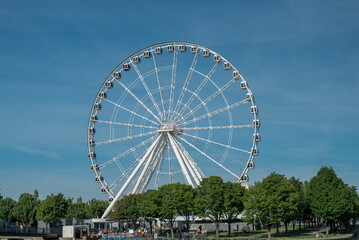 La grande Roue de Montreal, ferris wheel at Old Port Montreal, with blue sky. Montreal big wheel.