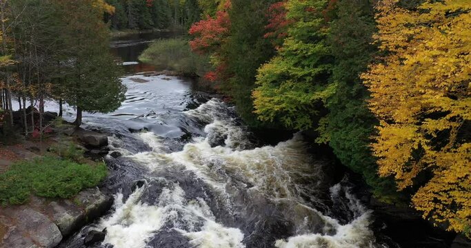 Aerial view of Buttermilk Falls with beautiful fall colors near Long Lake in the Adirondacks of Upstate New York during autumn.