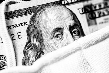 A hundred-dollar bill with a medical mask .The concept of coronavrius epidemic
