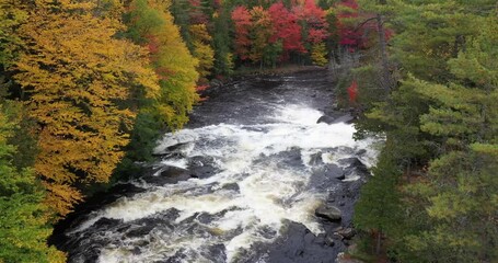 Aerial view of Buttermilk Falls with beautiful fall colors near Long Lake in the Adirondacks of Upstate New York during autumn.