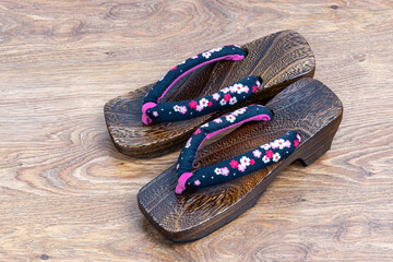 Japanese traditional geta sandal on wooden floor. Traditional Japanese asian wood footwear called...