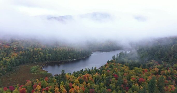 Connery Pond is seen through the fog and clouds near Whiteface Mountain in Adirondack Park, New York in fall.