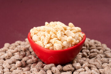 Roasted Crunchy Jowar and ragi - Indian Dietary Supplement, served in a bowl over moody background, selective focus.
