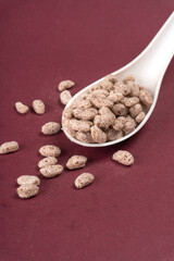 Roasted Crunchy Jowar and ragi - Indian Dietary Supplement, served in a bowl over moody background, selective focus.