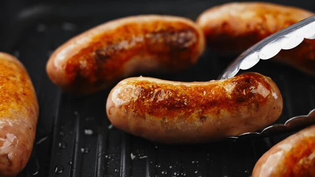 Delicious sausages are grilled on an electric grill