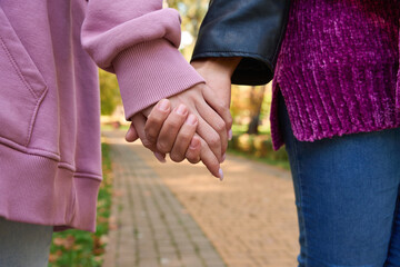 Lesbian couple in love walking in park