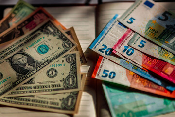 Unfolded denominations in dollars and euros on a notebook. Financial concept of currency exchange in the financial world. currency flow on the world. Financial problems in developed countries. 