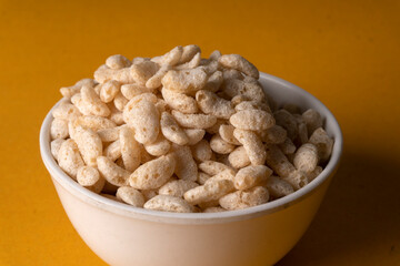 Roasted Crunchy Jowar and ragi - Indian Dietary Supplement, served in a bowl over moody background, selective focus.