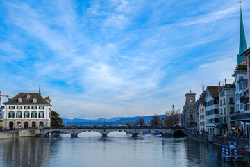 View on the Zurich lake shot from the limmat river. Blue Sky and a bridge can be seen in the picture.