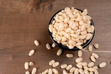 Roasted Crunchy Jowar and ragi - Indian Dietary Supplement, served in a bowl over moody background, selective focus.