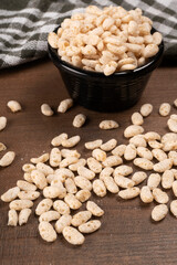 Roasted Crunchy Jowar and ragi - Indian Dietary Supplement, served in a bowl over moody background, selective focus.