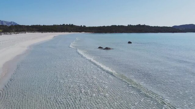 Grazing and panoramic flight over the Sardinian beach of Cala Brandinchi, pearl of the Mediterranean, near the island of Tavolara, Italy.