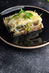 casserole vegetable lasagne eggplant, zucchini, green peas, cheese, bechamel sauce vegetables meal food snack on the table copy space food background rustic top view