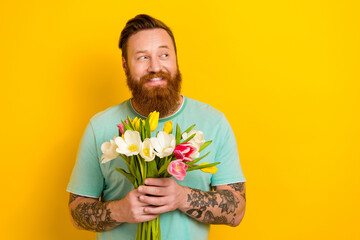 Photo of glad nice gentleman wear stylish clothes hold fresh flower look empty space interesting...