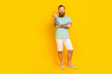 Full body photo of young man red hair long beard hipster outfit tattooed hands direct finger mockup summer sale isolated on yellow color background