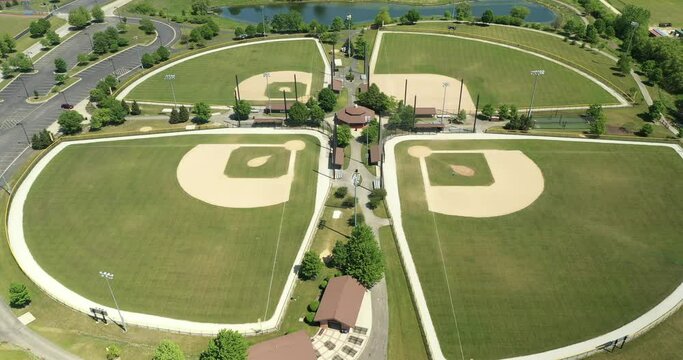 Aerial view of a suburban high school baseball complex with four ballfields.