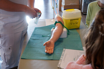 5th year medical students during an IV placement workshop. Students train on an arterial arm...