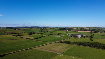 Clear sky over the green fields of southern Ireland. Picturesque summer landscape, sunny day. Green grass field under blue sky