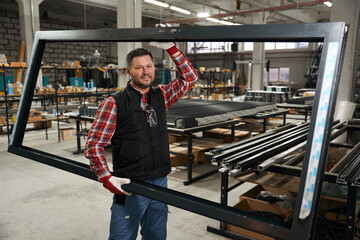Man carries finished product around the workshop