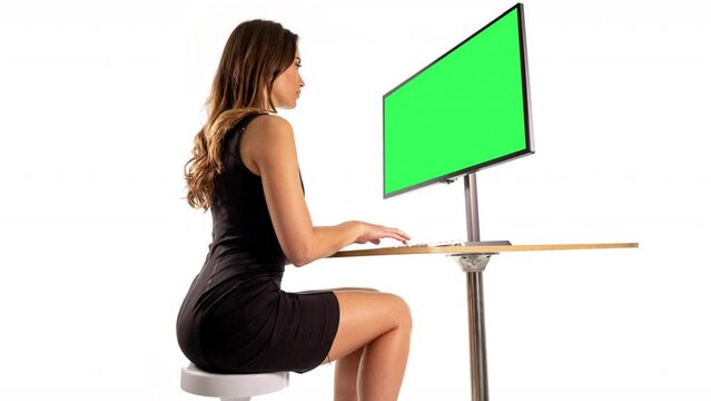 Female on a computer with green screen