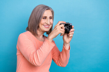 Portrait of friendly senior person bob hairdo wear pink shirt hold camera doing photo look empty...