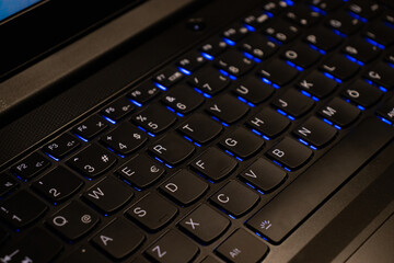 close-up of keys of blue backlit keyboard