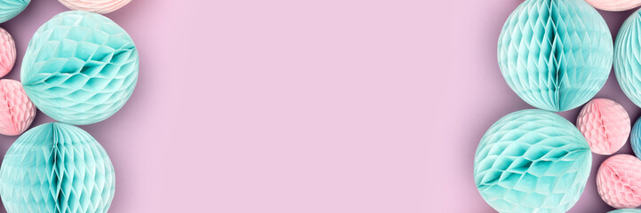 Banner with frame made of pink and blue tissue paper balls on a purple background. Place for your design.