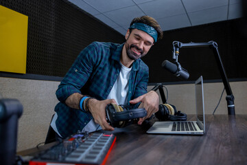 Radio dj with bandana on his head at the radio station