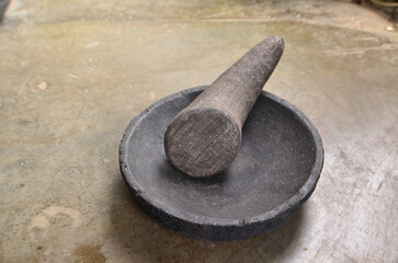 mortar and pestle are made of gray-black stones.