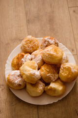 fragrant donuts sprinkled with powdered sugar in a plate