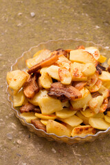 fried potatoes with slices of fried lard