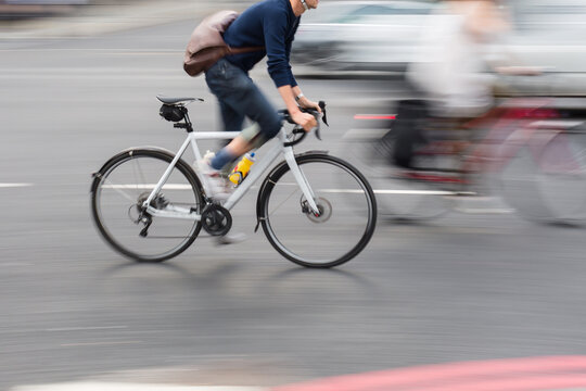 man on a racing bike in the city traffic